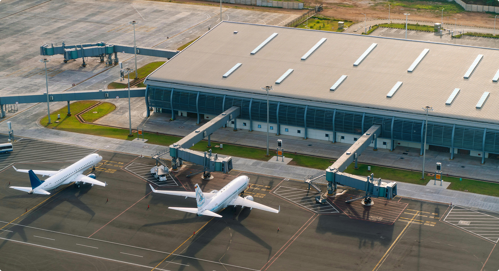 An image of planes stationed in front of an airport